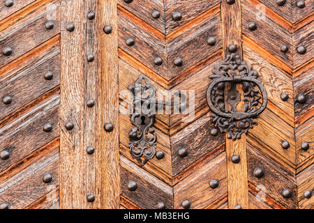 Vieille porte en bois avec serrure décorative en métal et heurtoir. Banque D'Images