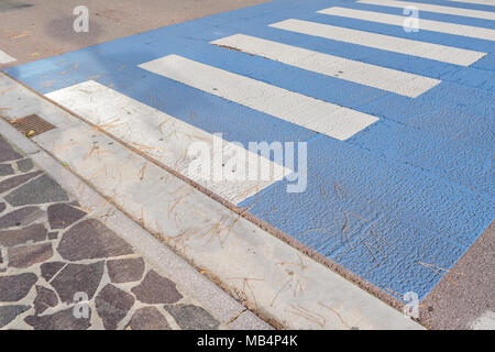 Contexte : passage pour piétons, que les gens utilisent pour traverser la route en toute sécurité, de ne pas être frappé par les voitures, des rayures de zèbre blanc et bleu, peint sur l'asphalte noir, au centre de Venezia, Italie Banque D'Images