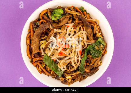 Style Chinois frits au wok Nouilles Bœuf Shanghai contre fond violet Banque D'Images