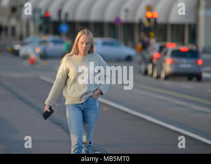 Fille blonde marcher seul dans Strömbron ('Le pont d'eau'), Stockholm, Suède Banque D'Images