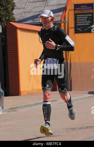 Checiny, Pologne, 7 avril 2018. Runner sur une rue. CROSSRUN amateur, l'exécution de la concurrence. Ce concours est divisé en deux catégories : 10 km et 21,5 km. Crédit : Pawel Burgiel/Alamy Live News. Banque D'Images