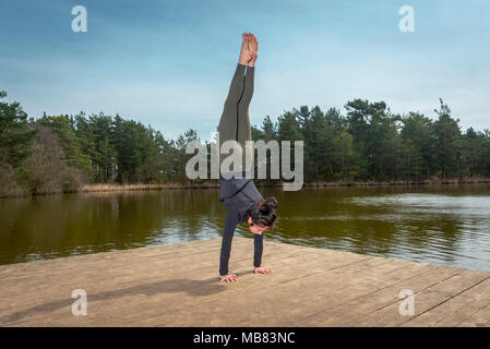 Femme faisant un handstand, yoga Banque D'Images