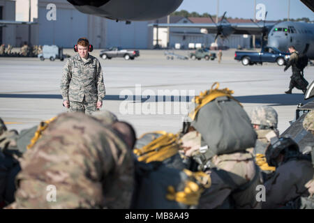 Le pape ARMY AIRFIELD, N.C. - Airman Tyler Greene, 43d de l'Escadron de mobilité aérienne Vol Port Aérien, regarde les parachutistes de la 82e Division aéroportée se préparent à charger un C-17 Globemaster III sur la rampe verte ici au 9 février 2018, au cours d'une semaine de gros paquets d'urgence et la disponibilité du déploiement se tiendra du 5 au 11 février. Aviateurs dans le 43d du Groupe des opérations de mobilité aérienne au Pape fourni l'appui au sol pour les équipages de l'Armée de l'air transport aérien de soldats et d'équipement hors du Pape domaine pendant l'exercice. Tout au long de la semaine, les équipes de l'Air Mobility Command effectué 173 missions, transportant plus de 3 Banque D'Images