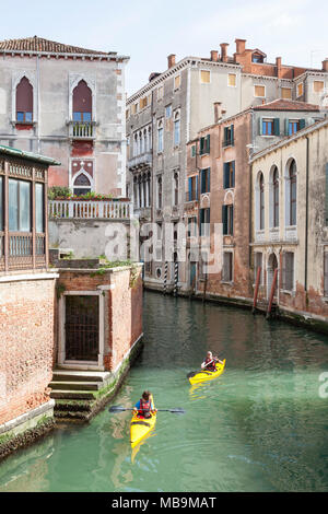 Rio San Polo, San Polo, Venise, Vénétie Italie avec deux location de kayaks jaunes avec les touristes à visiter la ville. L'activité vacances. Maison de l'activité. Banque D'Images