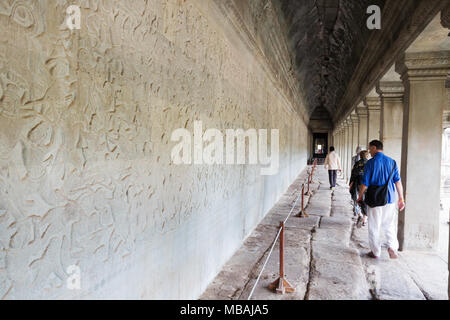 Les touristes à la recherche de sculptures sur pierre, temple d'Angkor Wat, temple hindou antique du 12ème siècle, site du patrimoine mondial de l'UNESCO, la Province de Siem Reap, Cambodge Asi Banque D'Images