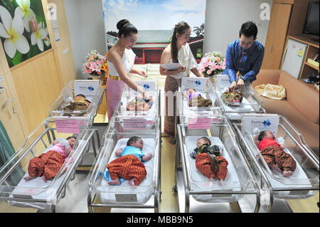 (180410) -- BANGKOK, 10 avril 2018 (Xinhua) -- un médecin (1e R) n Health Check pour un bébé nouveau-né habillé en costume traditionnel thaïlandais avant le prochain Festival de Songkran, le Nouvel An thaï, dans un hôpital de Bangkok, Thaïlande, avril. 10, 2018. (Xinhua/Sageamsak Rachen) (zjl) Banque D'Images