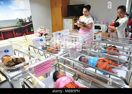 (180410) -- BANGKOK, 10 avril 2018 (Xinhua) -- les infirmières s'occupent de nouveau-nés habillés en costumes traditionnels thaïlandais avant le prochain Festival de Songkran, le Nouvel An thaï, dans un hôpital de Bangkok, Thaïlande, avril. 10, 2018. (Xinhua/Sageamsak Rachen) (zjl) Banque D'Images