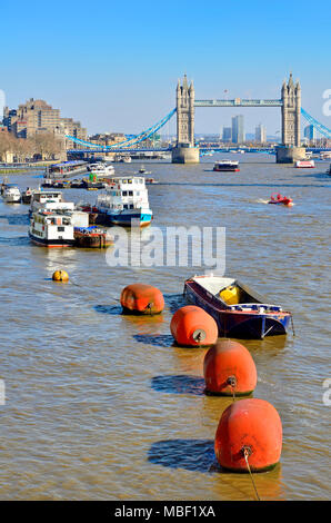 Londres, Angleterre, Royaume-Uni. Bateaux et de grosses bouées sur le rover de la Tamise, le Tower Bridge en arrière-plan Banque D'Images