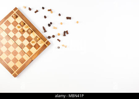 Vue de dessus de l'échiquier avec les pièces des échecs sur fond blanc. Banque D'Images