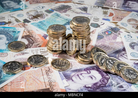 €1 pièces placées aléatoirement sur UK £5, £10, £20 et note Banque D'Images