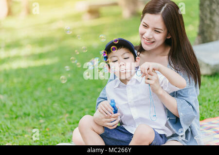 Belle asiatique jeune mère avec son fils le bonheur de jouer ensemble tout en moments pique-nique dans le parc en vacances pour maman unique concept Banque D'Images