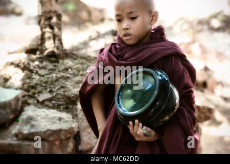 Jeune garçon moine passe pour le déjeuner à Kalaywa Tawya monastère à Yangon. 23 février 2014 - Yangon, Myanmar Banque D'Images