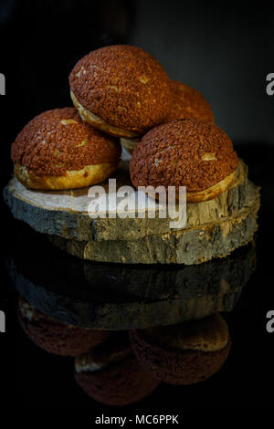 Français savoureux dessert shoo se trouve sur bois sur fond miroir noir Banque D'Images