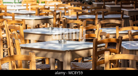 Athènes, Grèce. Taverne traditionnelle grecque tables et chaises vides à l'extérieur à Plaka. Banque D'Images