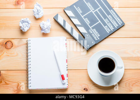 Un ordinateur portable, une tasse de café et d'un battant pour le tournage d'épisodes film sur des planches Banque D'Images