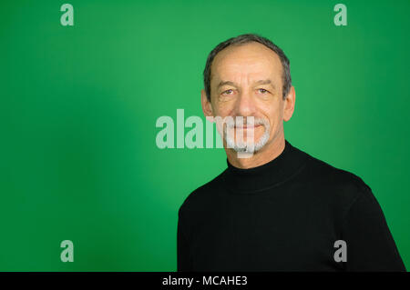 Visage masculin senior de l'homme et avait la barbe et les cheveux gris sur fond vert en Studio Banque D'Images