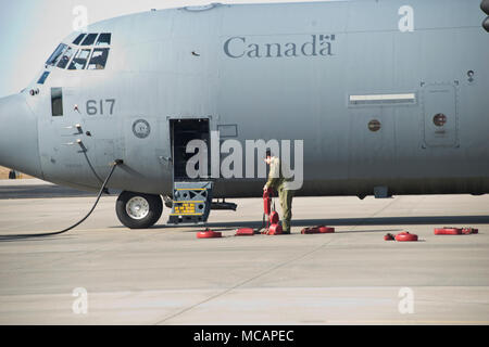 Un membre de la Force Aérienne Royale Canadienne des cales les roues de son CC-130J à Rosecrans Memorial Airport, St Joesph, Février 1, 2018 Ve après un vol d'entraînement pour le Traité sur le régime "Ciel ouvert". Le personnel de la United States, Canada, Royaume-Uni, la France et la République tchèque ont participé à ce vol conçu pour promouvoir la coopération internationale et de la transparence. (U.S. Air National Guard photo/Tech. Le Sgt. John Hillier) Banque D'Images