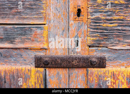 La desquamation de la peinture sur la vieille porte en bois patiné,. Fond texturé d'avancement appropriés utiliser... Banque D'Images