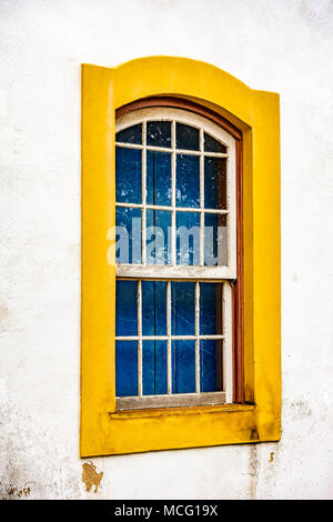 Vieille fenêtre en bois au style colonial avec un cadre jaune dans la ville d'Ouro Preto, Minas Grerais, Brésil Banque D'Images