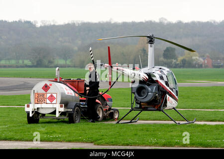 Hélicoptère Robinson R22 Beta être ravitaillé à Wellesbourne Airfield, Warwickshire, UK (G-WINR) Banque D'Images