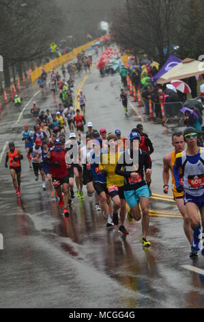 Newton, MA, USA 16 avril 2018 coureurs de marathon s'attaquer au temps orageux et la difficile montée de Heartbreak Hill pour compléter le marathon de Boston/Kirkikis Crédit : James Alamy Live News Banque D'Images