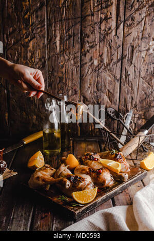 Cropped shot of woman pouring miel sur une délicieuse viande grillée Banque D'Images