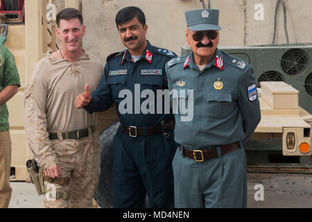 Le colonel Christopher J. Douglas, conseillère à la zone 505ème de la Police nationale afghane (PNA) avec la Force au sud-ouest (TFSW), un policier afghan (milieu), et Brigue. Le général Mohammad Gul Ahaj Chakhansori, commandant adjoint de la 505ème de l'ANP de zone (à droite), attendre pour dire au revoir aux visiteurs après une shura à l'Aérodrome de Bost, le 13 mars 2018. Les dirigeants de l'Armée nationale afghane 215e Corps et 505ème de se réunir, de l'ANP de zone avec leurs homologues TFSW, pour discuter des travaux en cours et des opérations de combat dans la province de Helmand. L'ANA et de la PNA travaillent ensemble en permanence, avec la formation et l'assistance de Banque D'Images