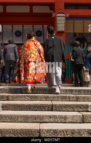 En couple traditionel japonais et monter des marches du sanctuaire à l'abri d'un parasol Banque D'Images