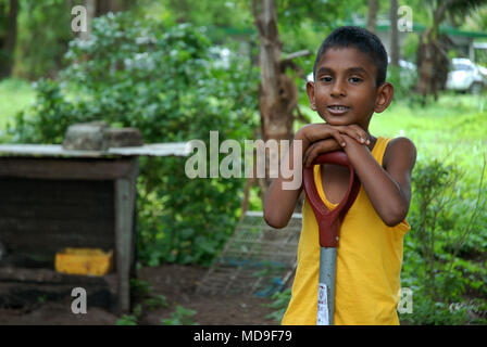 Garçon avec chat, Kulukulu, Sigatoka, Fiji. Banque D'Images