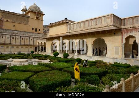 Femme indienne portant un sari jaune travaillant dans le jardin de l'Amber Fort Amer Jaipur Inde Rajashan Banque D'Images