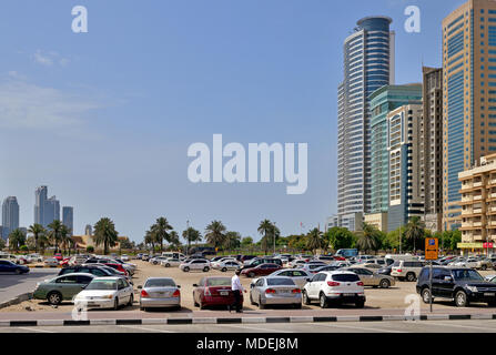 Sharjah, ÉMIRATS ARABES UNIS - 8 avril. En 2018. Parking gratuit dans le sable à côté d'immeubles de bureaux et résidentiels Banque D'Images