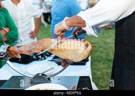 Man slicing un jamon iberico de bellota Banque D'Images