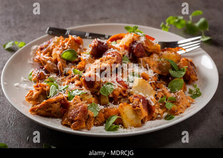 La plaque à l'omelette faite avec des oeufs, des pommes de terre, saucisses et fromage râpé Banque D'Images