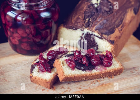 En gâteau au chocolat accompagné de remplissage avec sweet cherry en tête au sirop. Banque D'Images
