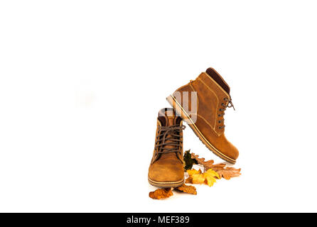 Cuir nubuck daim bottes marron avec feuilles d'automne mans Banque D'Images