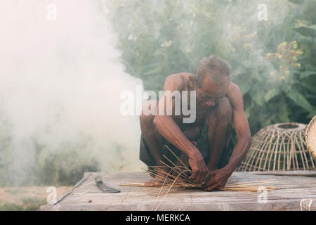 Les hommes asiatiques sont le tissage des paniers en bambou dans les régions rurales de la Thaïlande. Banque D'Images