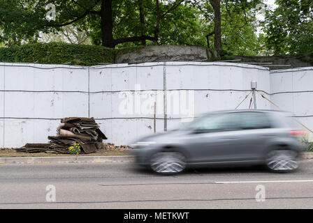 23 avril 2018, Allemagne, Stuttgart : une voiture passé parties du mur de mousse qui a été mis en place près de la porte de Neckar. (Prises avec exposition longue) Le mur faisait partie d'une expérience qui était censée clarifier si moss peuvent aider à réduire la poussière fine de la pollution dans les rues. Maintenant, elle a été supprimée. Photo : Sebastian Gollnow/dpa Banque D'Images