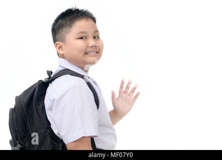 Asian boy étudiant qui part à l'école et salué isolé sur fond blanc, concept retour à l'école Banque D'Images