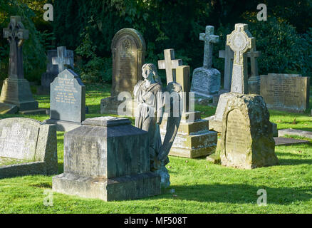 Ange déchu, un ange Sculpture sur une pierre tombale dans le cimetière est à côté de ses Ilkley plinth après avoir été arrachée à un moment donné dans le passé. Banque D'Images