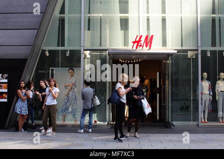 Les visiteurs devant une succursale de la multinationale suédoise du détaillant en vêtements H&M dans le quartier de Ginza. (Avril 2018) Banque D'Images