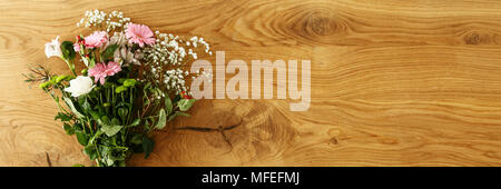 Vue du dessus de la main magnifique bouquet de fleurs fraîches pour la Fête des mères mis sur table en bois avec un espace vide de votre produit Banque D'Images