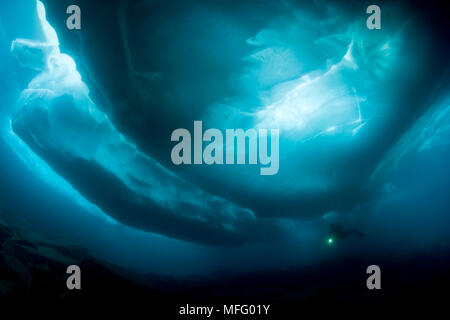Scuba Diver sous et entre les formations de glace, le lac Sassolo, Sambuco valley, Tessin, Suisse Banque D'Images