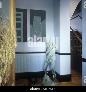 Un détail de couloir avec une petite statue d'un garçon photos sur le mur du parquet et une vue sur un escalier. Banque D'Images