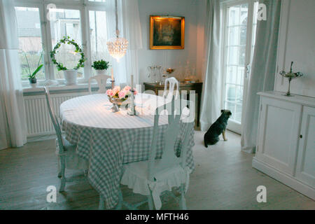 Vérifier avec table et chaises en bois en tissu blanc dans la salle à manger de style suédois Banque D'Images