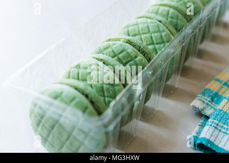 Lime ronde vert rempli de crème Cookies / Macarons dans un contenant de plastique. Apéritif bio Banque D'Images