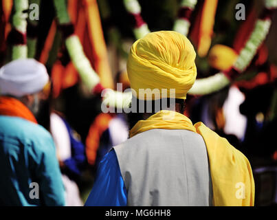 Homme Sikh avec turban jaune et noir au cours de la longue barbe rite religieux Banque D'Images