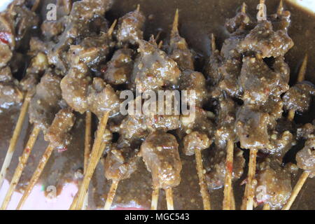 Cuisine traditionnelle indonésienne, le satay de chèvre est grillé à l'aide d'une brochette de bambou et donné de la sauce noire Banque D'Images