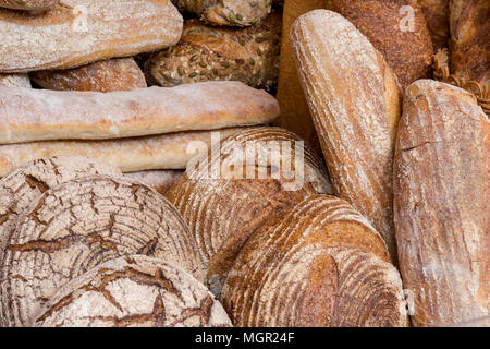Une sélection de rouleaux de boulangeries artisanales produites et pains sur l'affichage à un décrochage de boulangers sur Borough Market à Londres. Du pain artisanal à la boulangerie. Banque D'Images