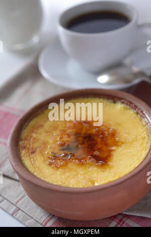 Crème catalane dans un pot et une tasse de café. L'accent sur un milieu sélectif de dessert Banque D'Images