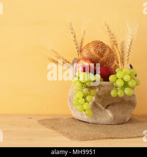 Droit de fruits et de pain dans le panier au-dessus de table en bois Banque D'Images